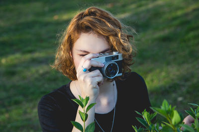 Portrait of woman photographing