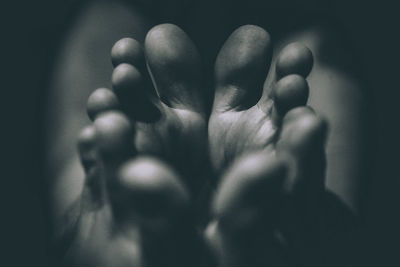Close-up of human hand against black background