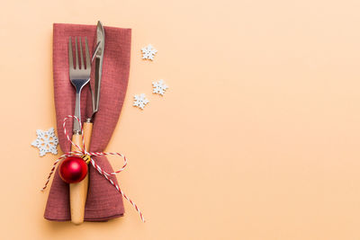 Directly above shot of christmas decoration against pink background