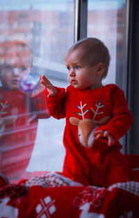 Cute boy against window