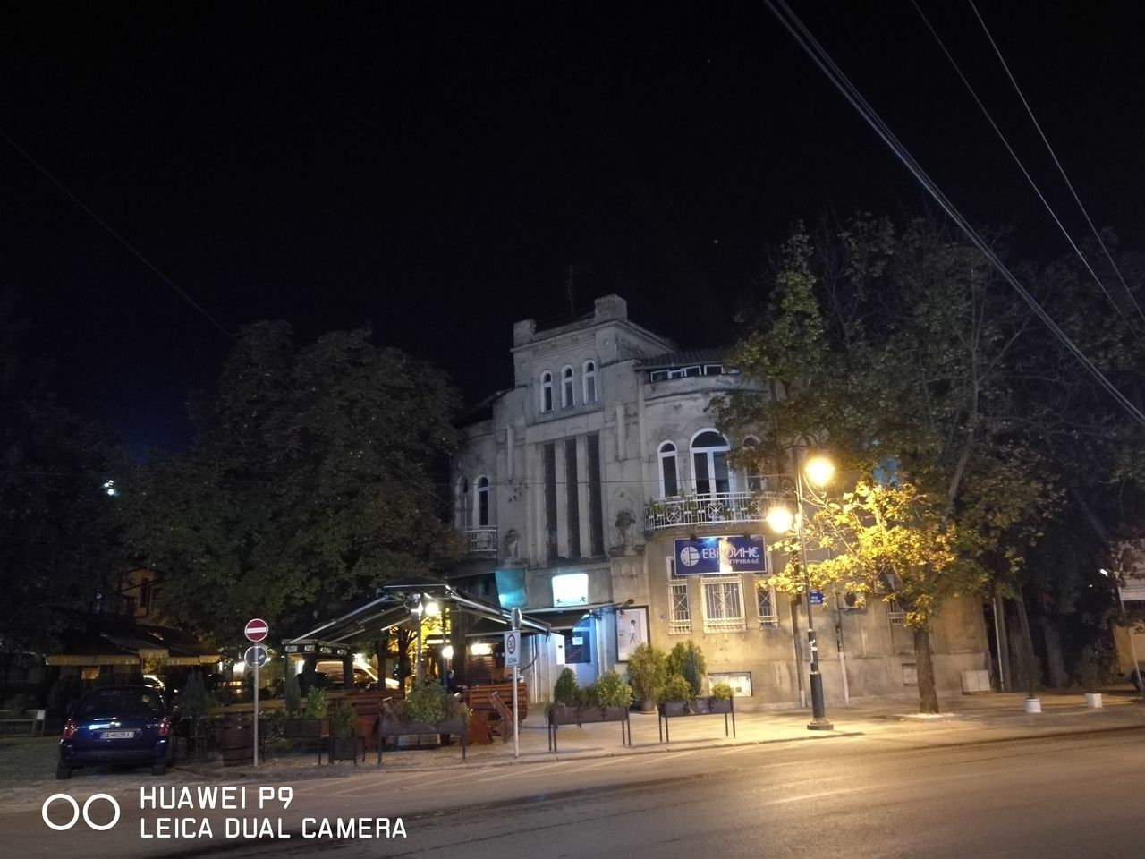 ROAD ALONG BUILDINGS AT NIGHT