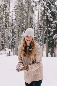 Portrait of a smiling young woman in snow