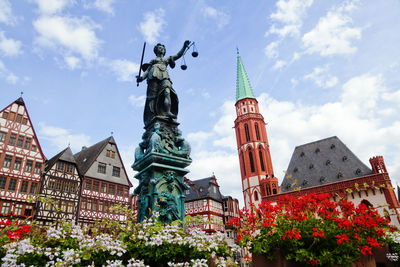 Low angle view of statue against cloudy sky