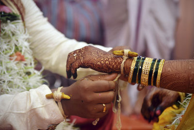 Midsection of couple at wedding ceremony
