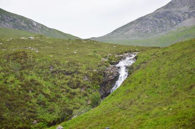 Scenic view of waterfall against sky