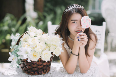 Portrait of a beautiful woman holding flower