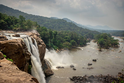 Scenic view of waterfall against sky