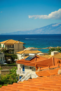 High angle view of townscape by sea against sky