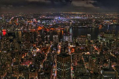 High angle view of city lit up at night