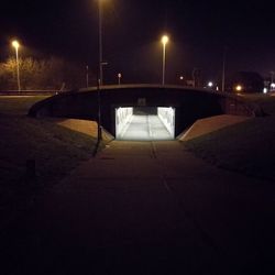 Illuminated light bulb on soccer field at night