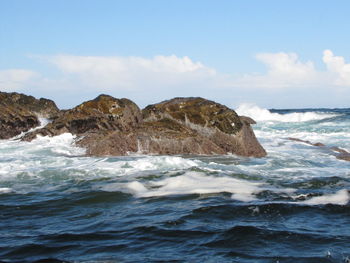 Breaking waves and rocks at the coast