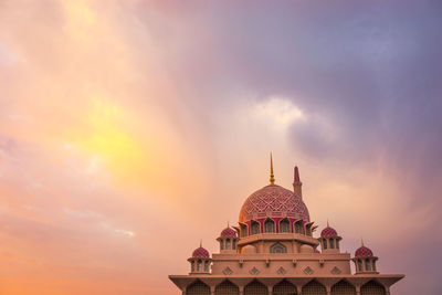 Temple against sky at sunset