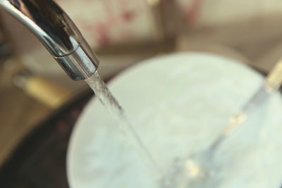 Close-up of faucet in water