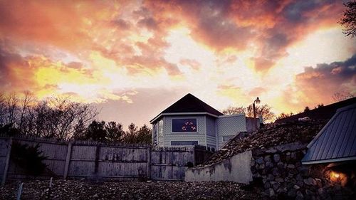 Low angle view of house against cloudy sky