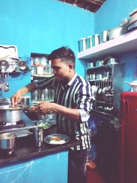 Side view of a man working in kitchen