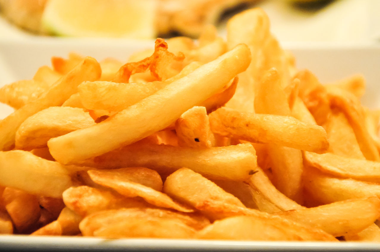 CLOSE-UP OF FRIES AND MEAT AND POTATOES
