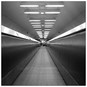 Low angle view of illuminated underground walkway