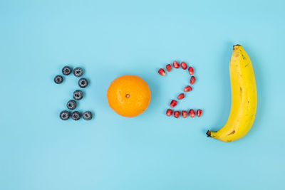 High angle view of fruits against blue background