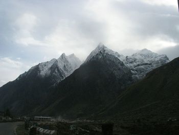 Scenic view of mountains against cloudy sky