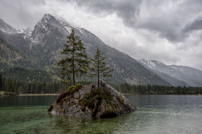 Scenic view of lake by mountains against sky