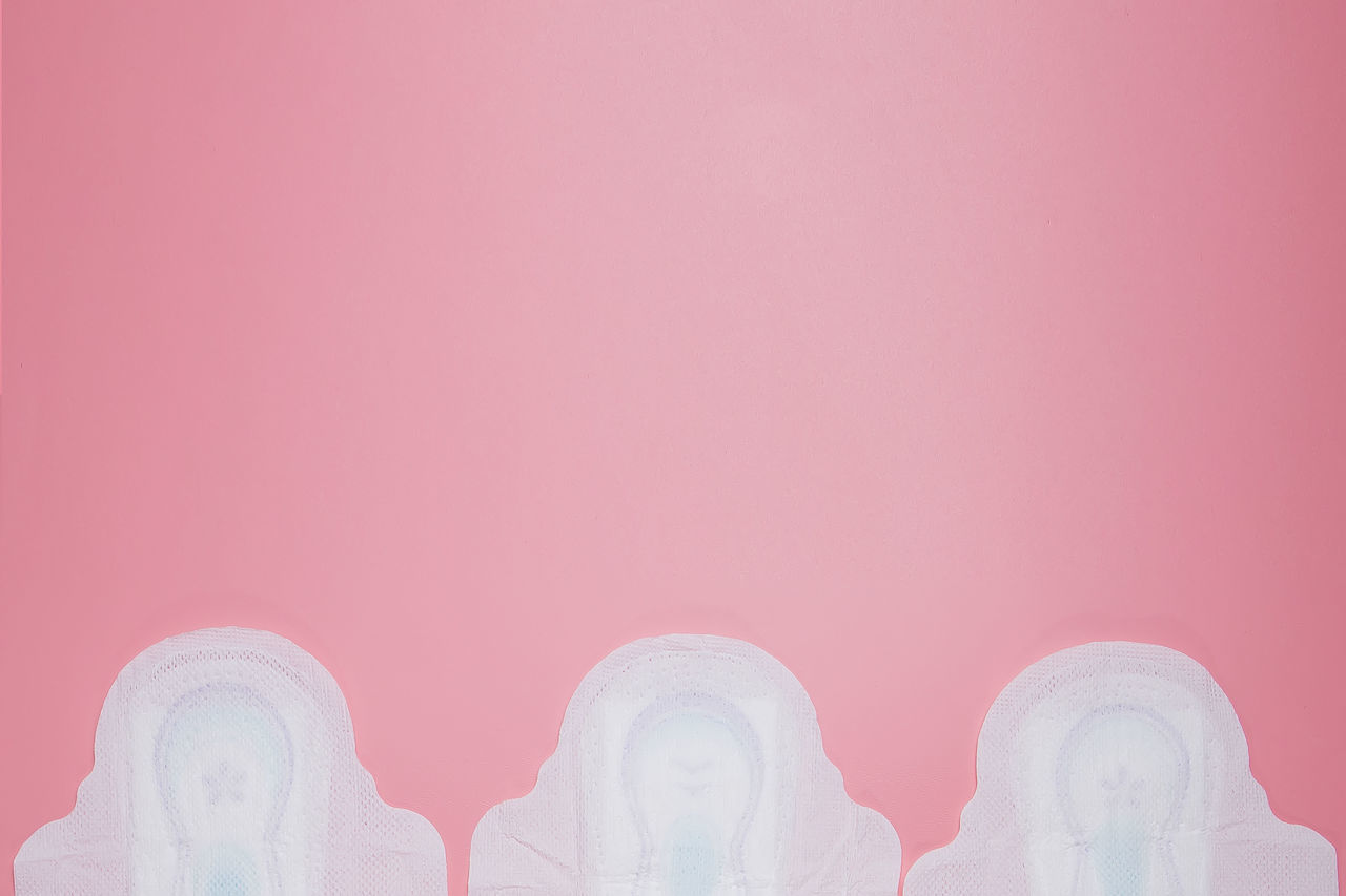 CLOSE-UP OF PINK ART AGAINST GRAY BACKGROUND