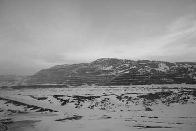 Scenic view of mountains against cloudy sky