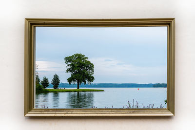 Scenic view of sea against sky seen through window