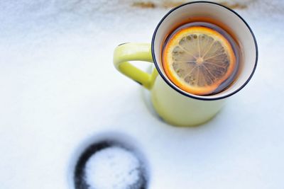 Close-up of drink in cup on snow