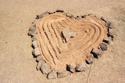 High angle view of heart shape on sand