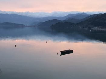 Scenic view of lake against sky during sunset