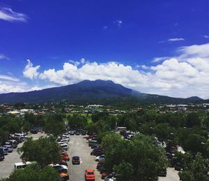 High angle view of city against blue sky