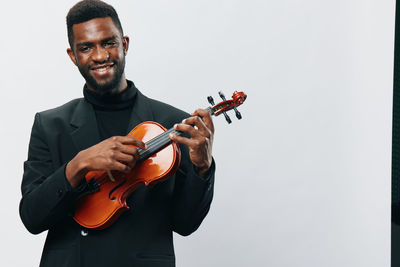 Man playing violin against white background