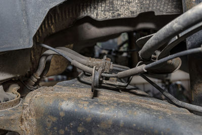 Old brake hose system, mounted to the car, visible parts of the brake system and tube fittings.