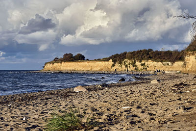 Panoramic view of rocks on beach against sky