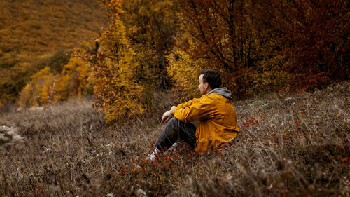 Rear view of woman standing on field