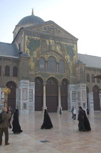 Group of people in front of historic building