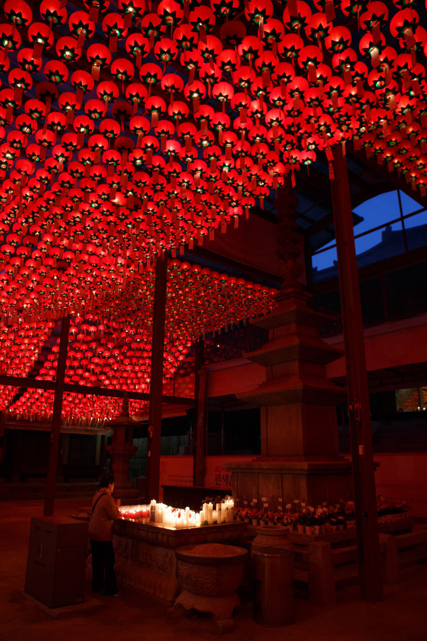 PEOPLE IN ILLUMINATED BUILDING