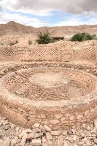 View of old ruins against cloudy sky