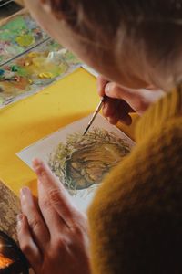 Close-up of hand holding painting