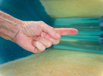 Close-up of people hands in swimming pool