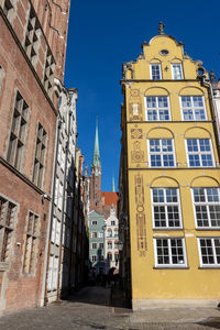Low angle view of buildings against sky in city