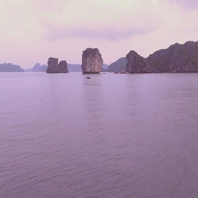 water, tranquil scene, tranquility, sky, scenics, sea, beauty in nature, rock formation, mountain, waterfront, nature, rock - object, idyllic, cloud - sky, cloud, rippled, cliff, remote, non-urban scene, rock