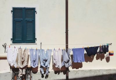 Clothes drying on clothesline against building