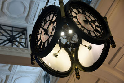 Low angle view of illuminated lighting equipment hanging on ceiling