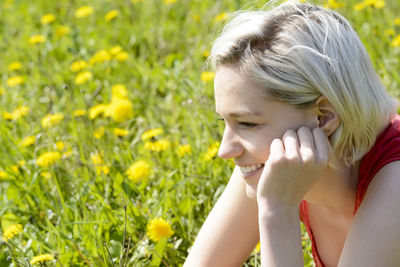 Close-up of young woman looking away on grass