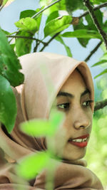 Close-up of young woman in hijab looking away