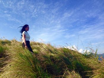 Rear view of woman standing on grass