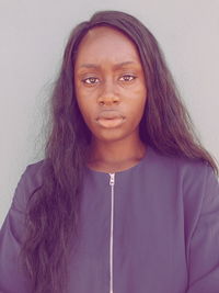 Portrait of beautiful woman standing against wall