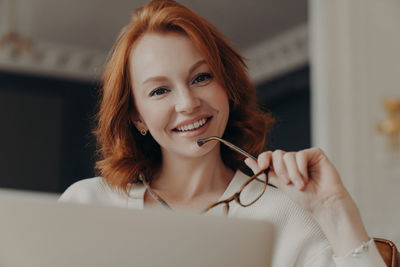 Young woman using laptop at home