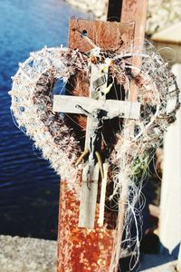 Close-up of tied up on wooden post